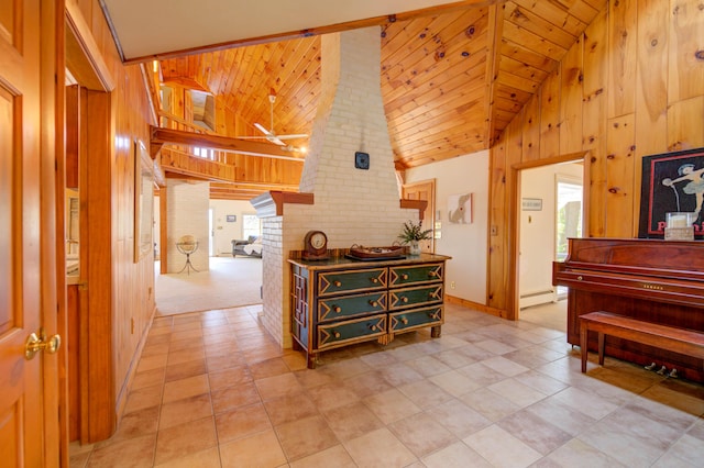 27 Chickadee Ln, Naples, ME 04055 - corridor with wooden walls, high vaulted ceiling, a baseboard heating unit, baseboards, and light tile patterned floors