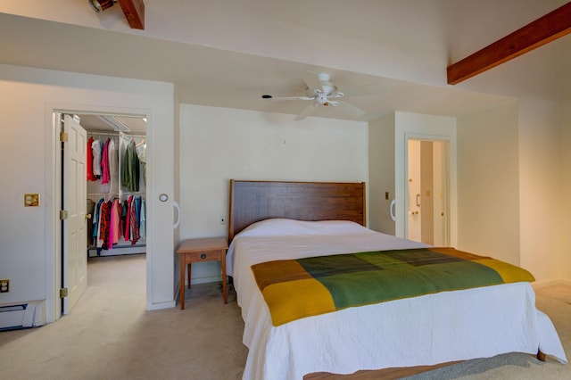27 Chickadee Ln, Naples, ME 04055 - carpeted bedroom featuring a walk in closet, beam ceiling, a baseboard radiator, a closet, and a ceiling fan