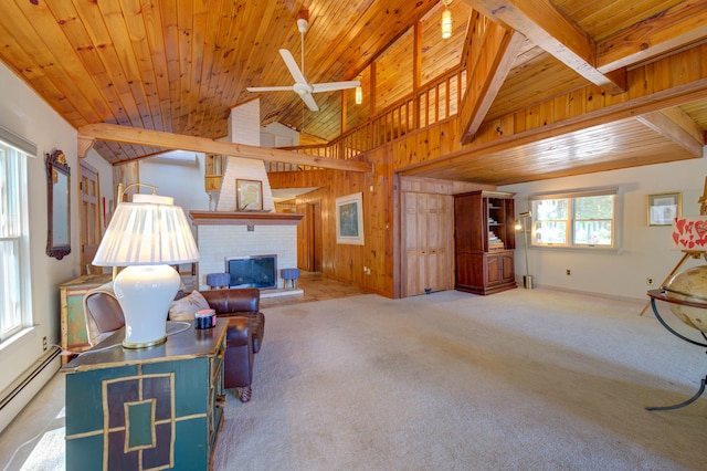 27 Chickadee Ln, Naples, ME 04055 - living room with baseboard heating, ceiling fan, carpet, a fireplace, and wooden ceiling with exposed beams