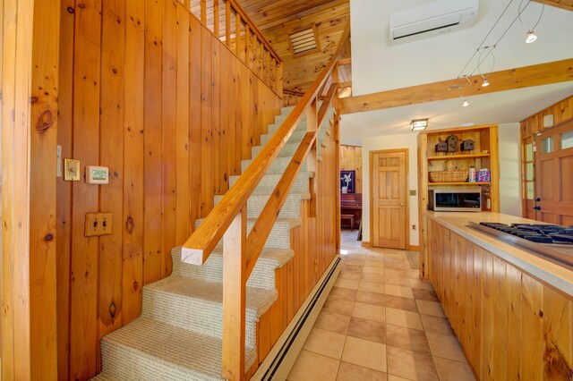 27 Chickadee Ln, Naples, ME 04055 - stairs with a wall mounted air conditioner, a baseboard radiator, tile patterned flooring, and wooden walls