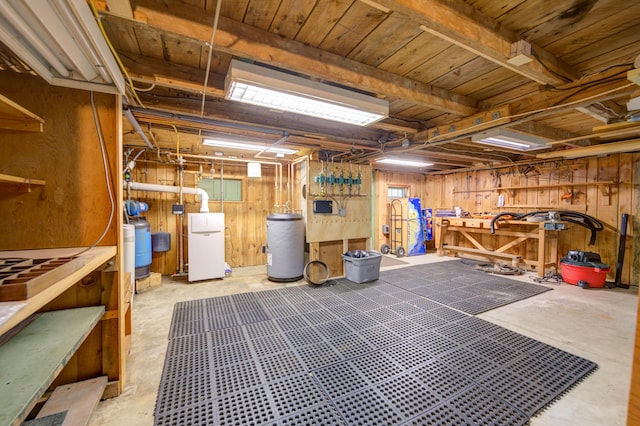 27 Chickadee Ln, Naples, ME 04055 - basement featuring a workshop area, wooden walls, and water heater