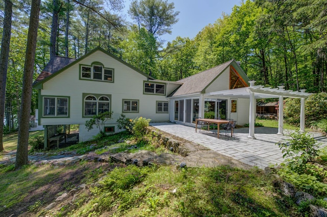 27 Chickadee Ln, Naples, ME 04055 - rear view of property featuring a pergola and a patio