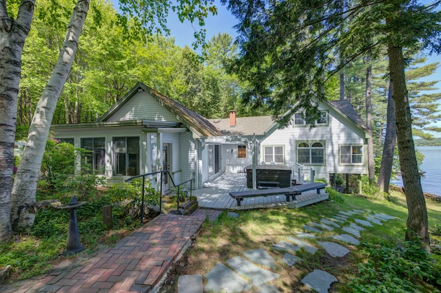 27 Chickadee Ln, Naples, ME 04055 - view of front of house with a hot tub, a deck, and a chimney