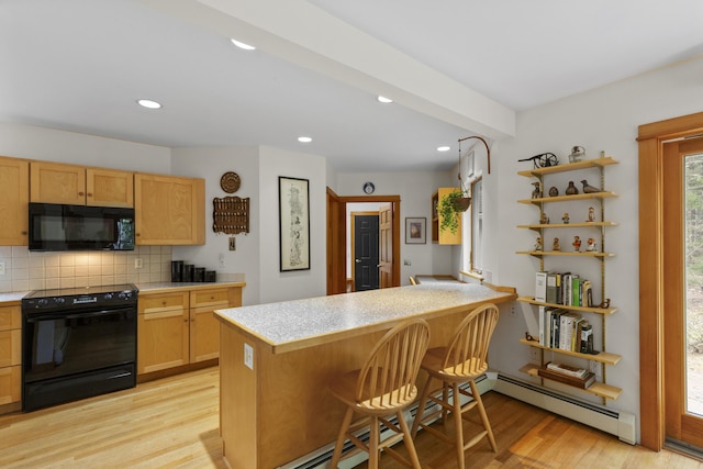 68 Parker Farm Rd, Mount Desert, ME 04660 - kitchen with black appliances, light countertops, light wood finished floors, backsplash, and recessed lighting