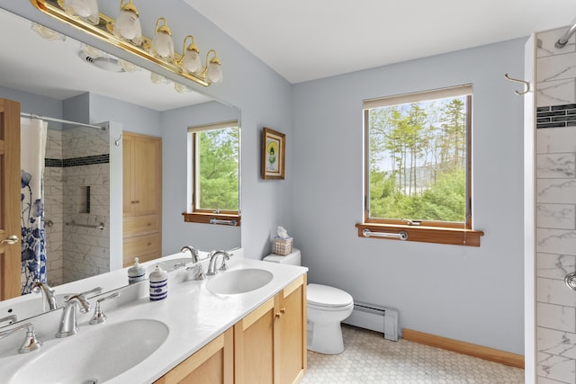 68 Parker Farm Rd, Mount Desert, ME 04660 - full bathroom with baseboard heating, a tile shower, baseboards, toilet, and double vanity