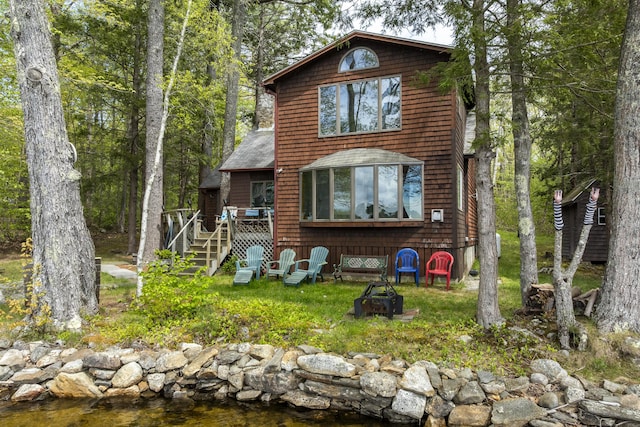 711 Biscay Rd, Bremen, ME 04551 - rustic home with a wooden deck and stairs