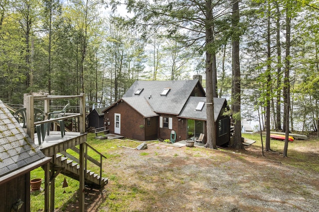 711 Biscay Rd, Bremen, ME 04551 - rear view of property with roof with shingles, a wooden deck, and a chimney