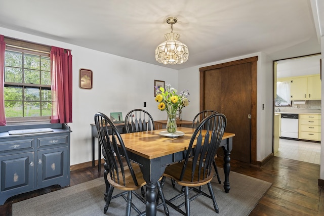 711 Biscay Rd, Bremen, ME 04551 - dining room featuring dark wood-type flooring, a chandelier, and baseboards