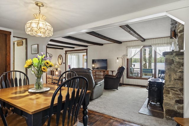711 Biscay Rd, Bremen, ME 04551 - dining room with hardwood / wood-style flooring, a chandelier, a wood stove, and beam ceiling