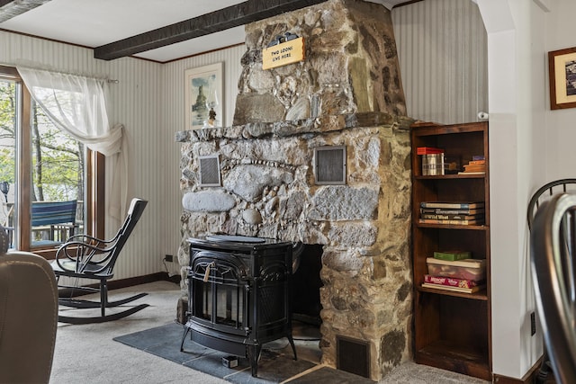 711 Biscay Rd, Bremen, ME 04551 - living area featuring a wood stove, carpet, beamed ceiling, and baseboards