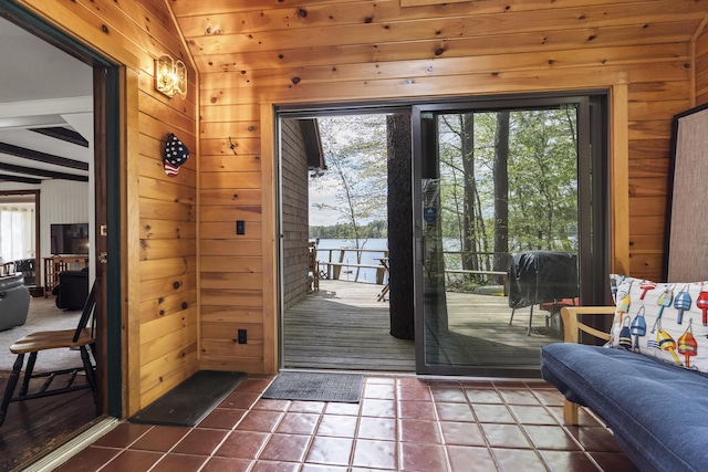 711 Biscay Rd, Bremen, ME 04551 - entryway featuring wooden walls, dark tile patterned floors, and a water view