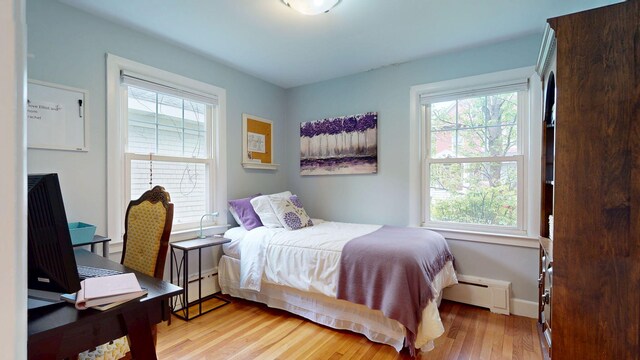 22 Vincent St, South Portland, ME 04106 - bedroom with a baseboard heating unit, light wood-type flooring, and baseboards