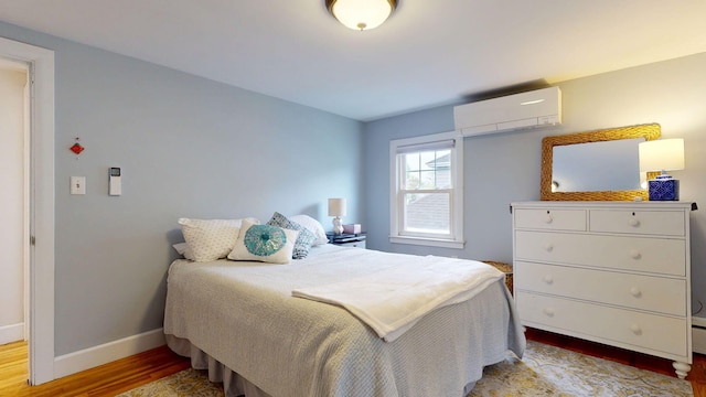 22 Vincent St, South Portland, ME 04106 - bedroom with a wall unit AC, light wood finished floors, and baseboards