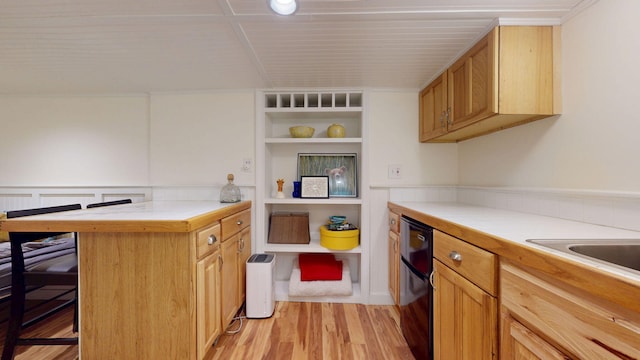 22 Vincent St, South Portland, ME 04106 - kitchen with light wood-style floors, a peninsula, open shelves, a kitchen bar, and black dishwasher
