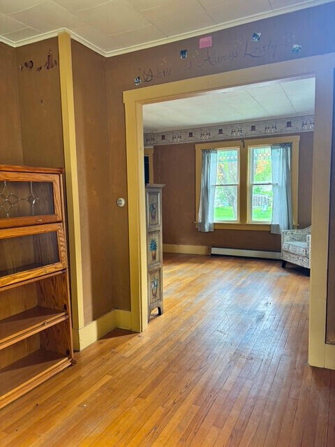 3 King St, Sanford, ME 04083 - empty room with light wood-style floors, baseboards, and baseboard heating