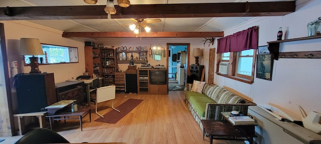 208 Camp Rd, Cooper, ME 04657 - living room with light wood finished floors, a ceiling fan, beam ceiling, and cooling unit