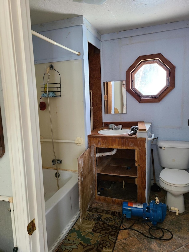 208 Camp Rd, Cooper, ME 04657 - bathroom featuring toilet,  shower combination, and vanity