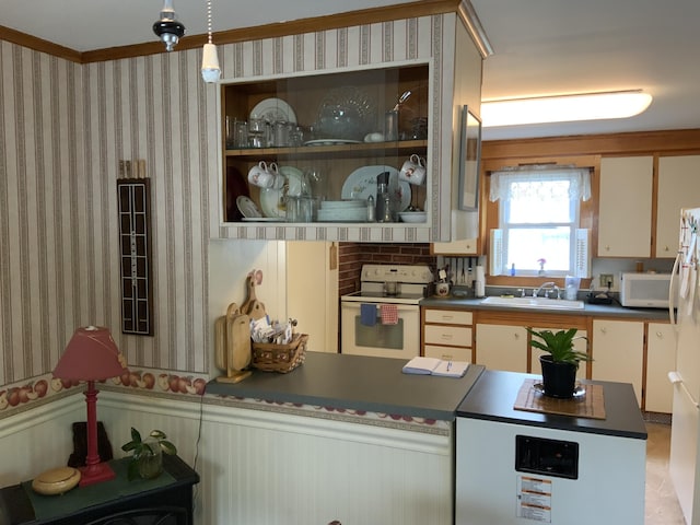39 Oak St, Waterville, ME 04901 - kitchen featuring white appliances, a sink, a wainscoted wall, dark countertops, and wallpapered walls