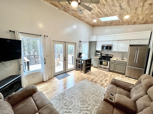 80 Bluejay Ln, Waltham, ME 04605 - living room with a ceiling fan, wooden ceiling, light wood-type flooring, high vaulted ceiling, and a skylight