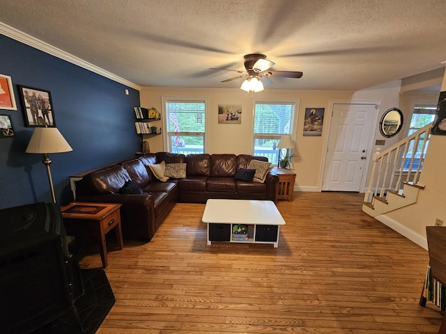 33 Oak Ridge Dr, Standish, ME 04084 - living room with a textured ceiling, a ceiling fan, hardwood / wood-style flooring, stairs, and ornamental molding
