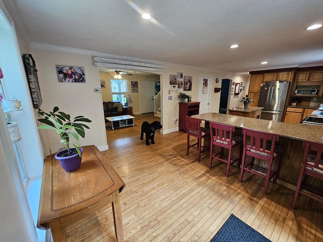 33 Oak Ridge Dr, Standish, ME 04084 - dining room with crown molding, light wood finished floors, recessed lighting, baseboards, and a ceiling fan