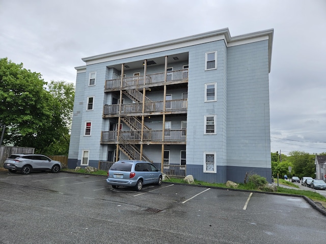 308 Bates St, Lewiston, ME 04240 - view of apartment building / complex featuring stairway and uncovered parking