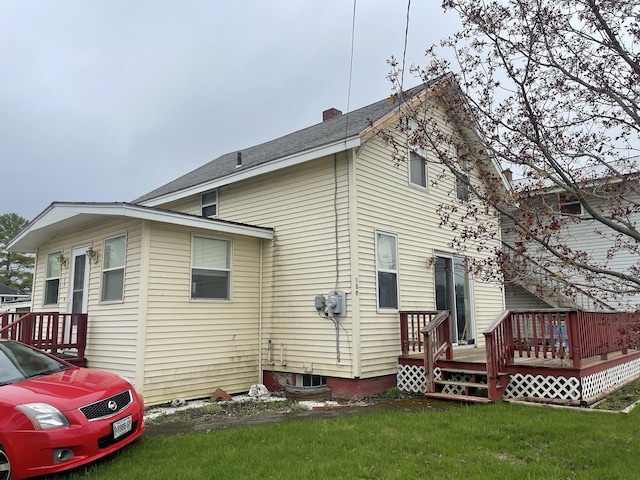 1 S Park St, Caribou, ME 04736 - rear view of property featuring a deck, a yard, and a chimney