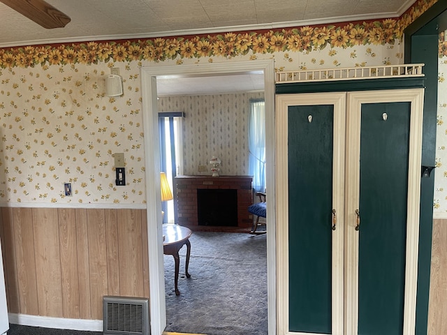 1 S Park St, Caribou, ME 04736 - interior space with wallpapered walls, wainscoting, a brick fireplace, and wooden walls
