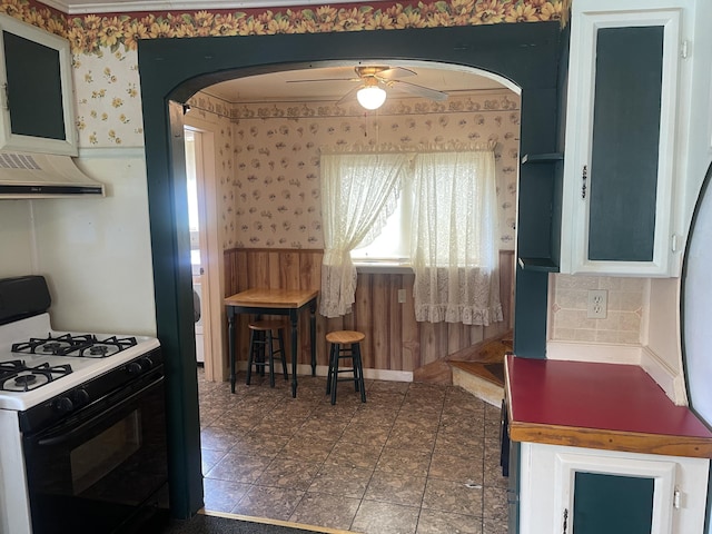 1 S Park St, Caribou, ME 04736 - kitchen featuring gas stove, arched walkways, wallpapered walls, ceiling fan, and ventilation hood