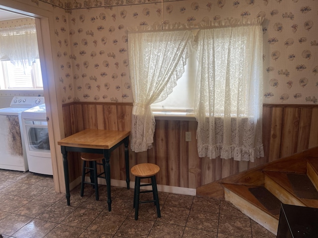 1 S Park St, Caribou, ME 04736 - dining room featuring wallpapered walls, separate washer and dryer, a wainscoted wall, and wood walls