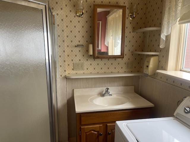 1 S Park St, Caribou, ME 04736 - bathroom with washer / dryer, wallpapered walls, wainscoting, a shower stall, and vanity