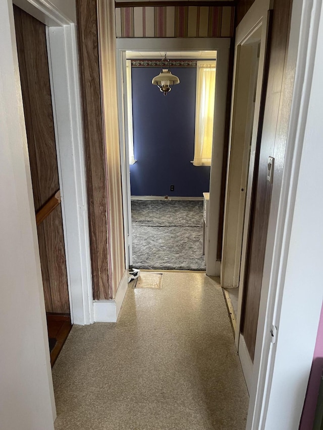 1 S Park St, Caribou, ME 04736 - hall with baseboards, a chandelier, and carpet flooring