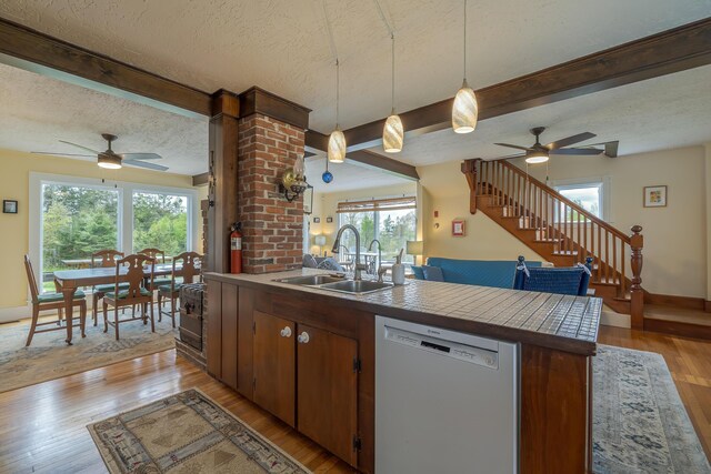 30 Hardys Hill Rd, Deer Isle, ME 04627 - kitchen featuring dishwasher, ceiling fan, a sink, a textured ceiling, and a peninsula