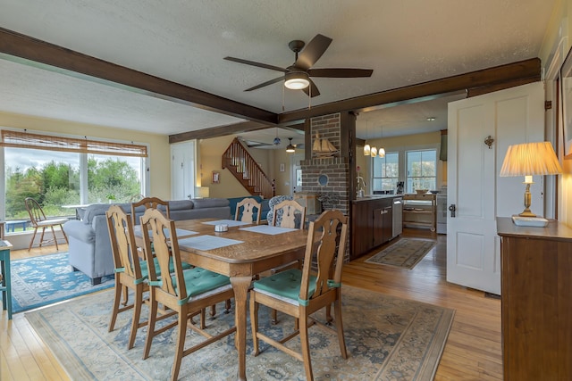 30 Hardys Hill Rd, Deer Isle, ME 04627 - dining space with ceiling fan, light wood-style flooring, a textured ceiling, beam ceiling, and stairs