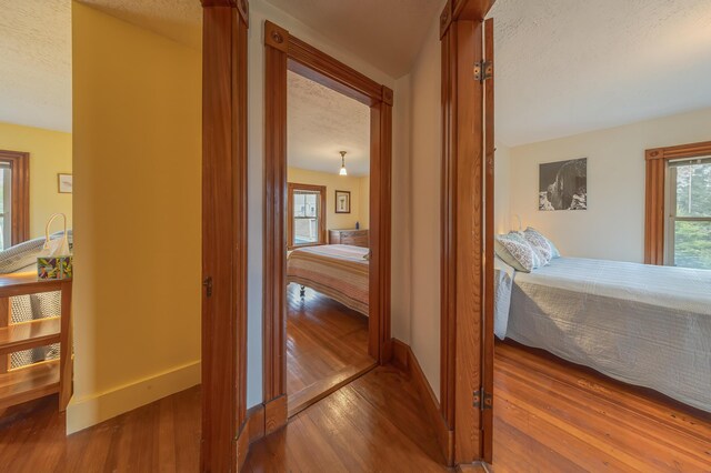 30 Hardys Hill Rd, Deer Isle, ME 04627 - corridor with wood finished floors, baseboards, and a textured ceiling