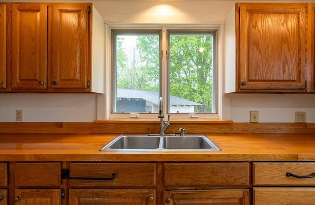 229 Choate Rd, Montville, ME 04941 - kitchen with a sink, brown cabinets, and wooden counters