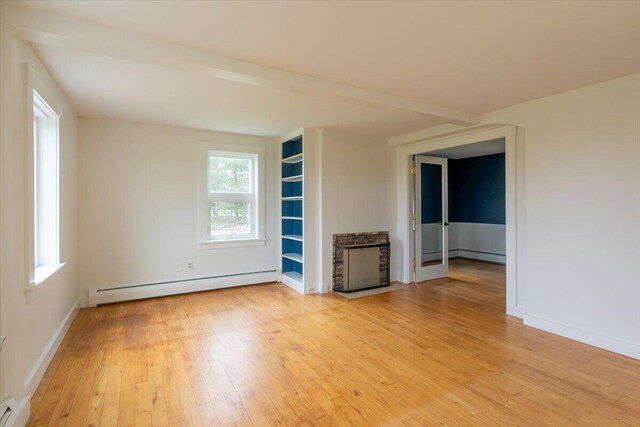229 Choate Rd, Montville, ME 04941 - empty room featuring baseboard heating, light wood finished floors, baseboards, and heating unit