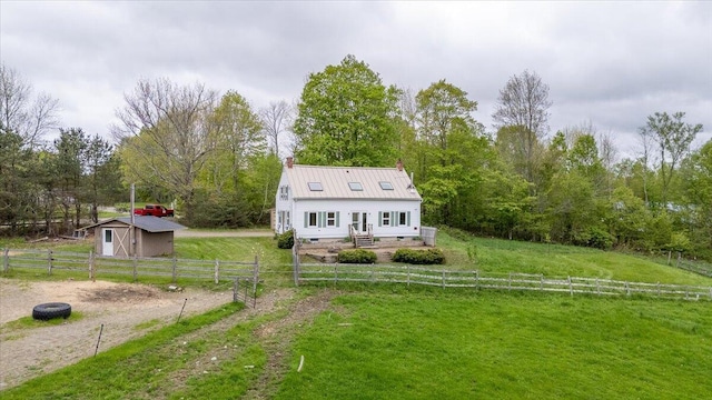 229 Choate Rd, Montville, ME 04941 - view of front of house featuring a chimney, an outbuilding, metal roof, and a view of countryside