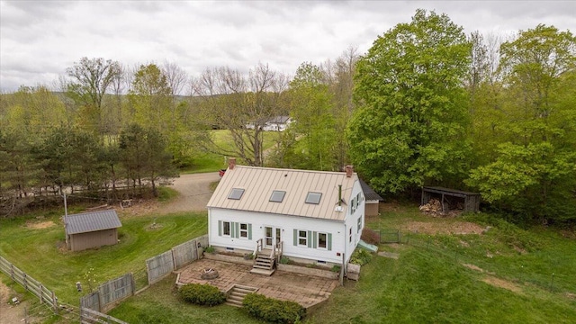229 Choate Rd, Montville, ME 04941 - view of front of home with a chimney, metal roof, a standing seam roof, and an outbuilding