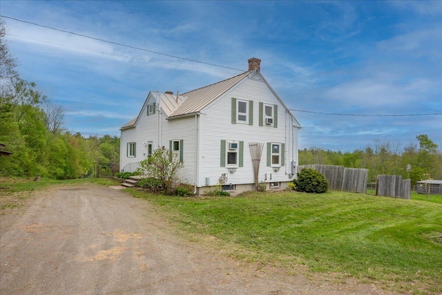 229 Choate Rd, Montville, ME 04941 - view of front of home with a chimney, metal roof, driveway, and a standing seam roof
