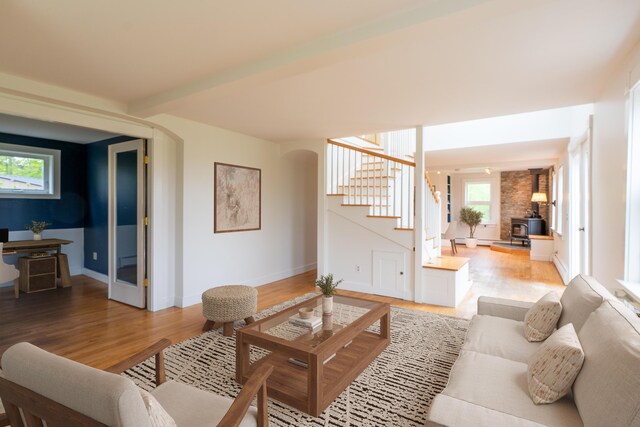 229 Choate Rd, Montville, ME 04941 - living room with stairway, light wood finished floors, a wood stove, and baseboards