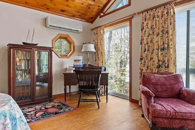 641 Bald Mountain Rd, Rangeley, ME 04970 - bedroom featuring a wall mounted AC, vaulted ceiling, wood finished floors, access to outside, and baseboards