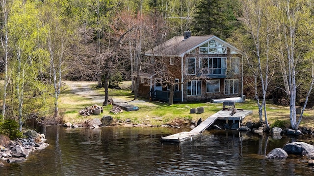 641 Bald Mountain Rd, Rangeley, ME 04970 - dock area with a balcony, a forest view, a water view, and a lawn