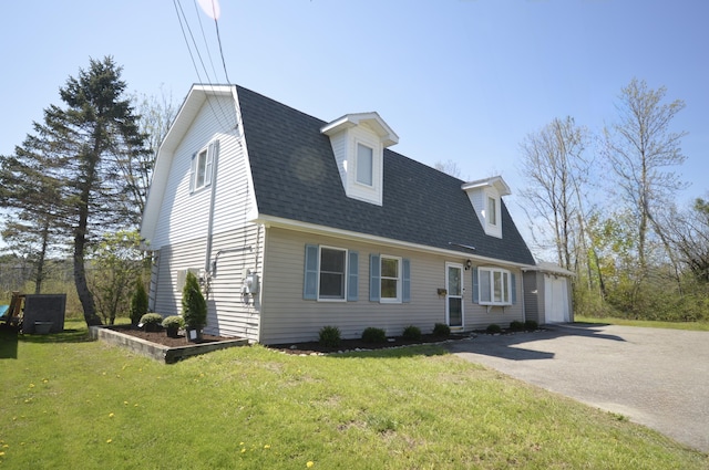 42 Blanchard St, Bangor, ME 04401 - dutch colonial with driveway, roof with shingles, a front lawn, and a gambrel roof
