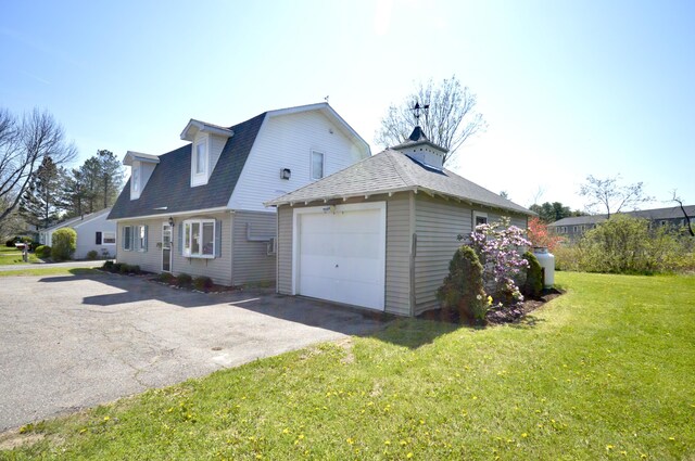 42 Blanchard St, Bangor, ME 04401 - view of home's exterior with driveway, an outdoor structure, a shingled roof, a gambrel roof, and a lawn