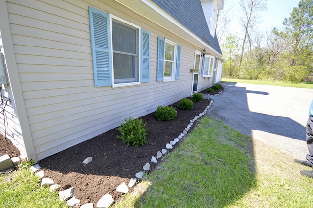42 Blanchard St, Bangor, ME 04401 - view of side of home with a patio area, roof with shingles, and a yard