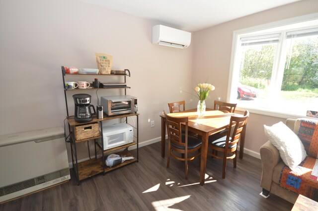 42 Blanchard St, Bangor, ME 04401 - dining area with a wall mounted AC, baseboards, dark wood-type flooring, and heating unit