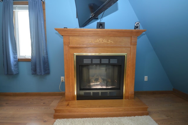 42 Blanchard St, Bangor, ME 04401 - detailed view of a glass covered fireplace, wood finished floors, and baseboards