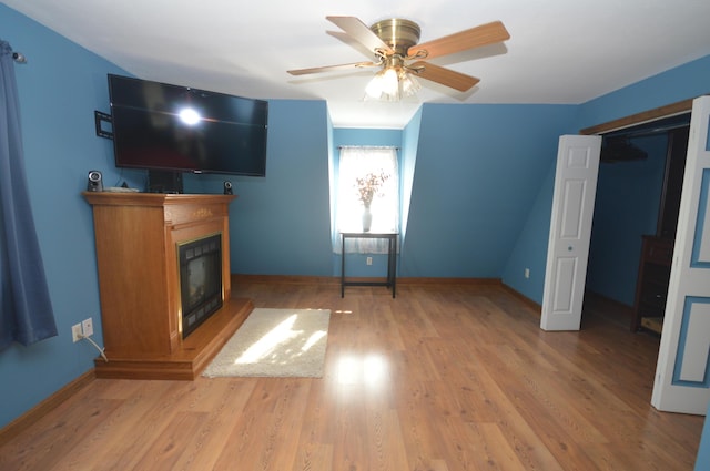 42 Blanchard St, Bangor, ME 04401 - unfurnished living room with light wood finished floors, a glass covered fireplace, baseboards, and ceiling fan
