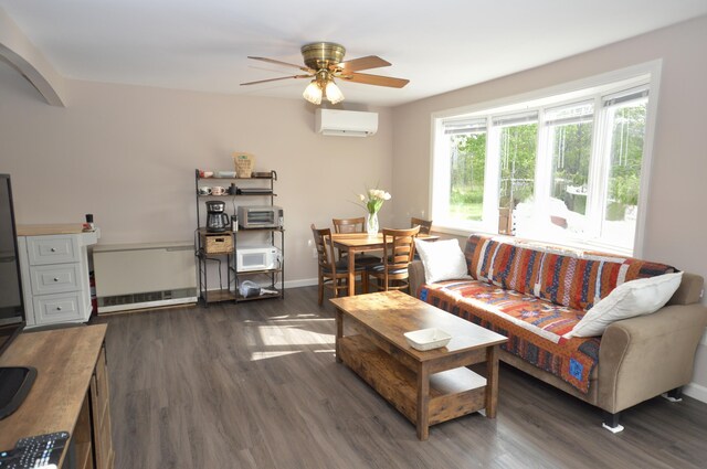 42 Blanchard St, Bangor, ME 04401 - living area with an AC wall unit, wood finished floors, a ceiling fan, and baseboards